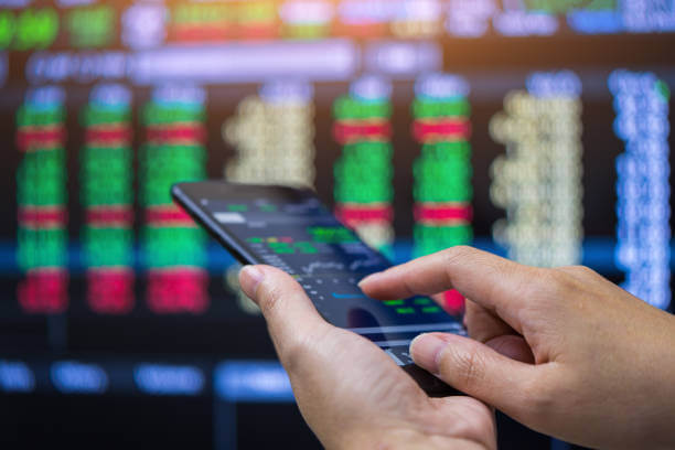 Businessman checking stock market on mobile phone,Stock market